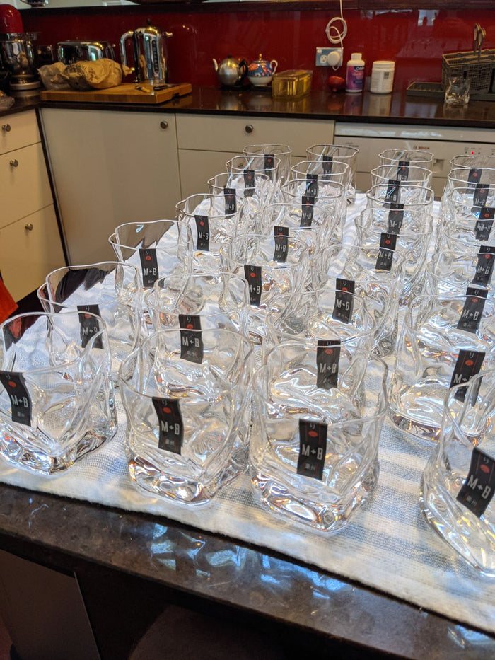 Tagged Twist glasses lined up on the kitchen bench, December 2020