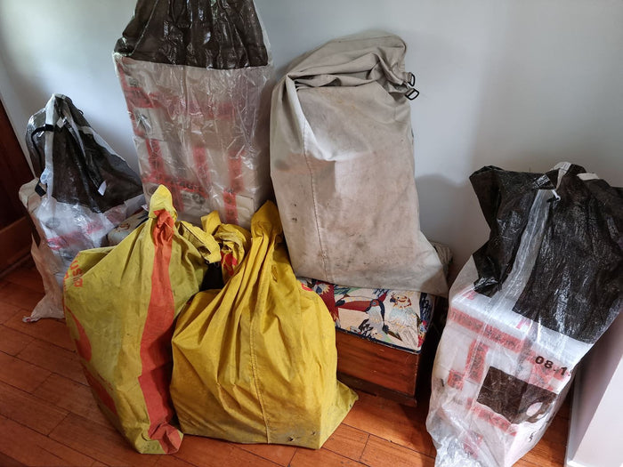 Bags of stock against the hallway wall, November 2021