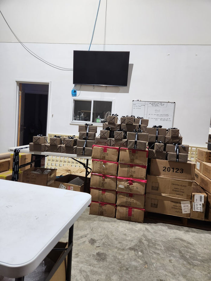 A wall of gift-wrapped sets for the Continental Tyres order stacked under the TV, July 2023